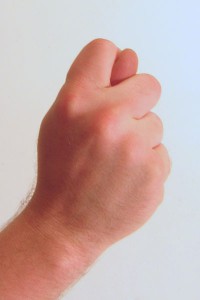 Russian gesture fist with thumb through fingers